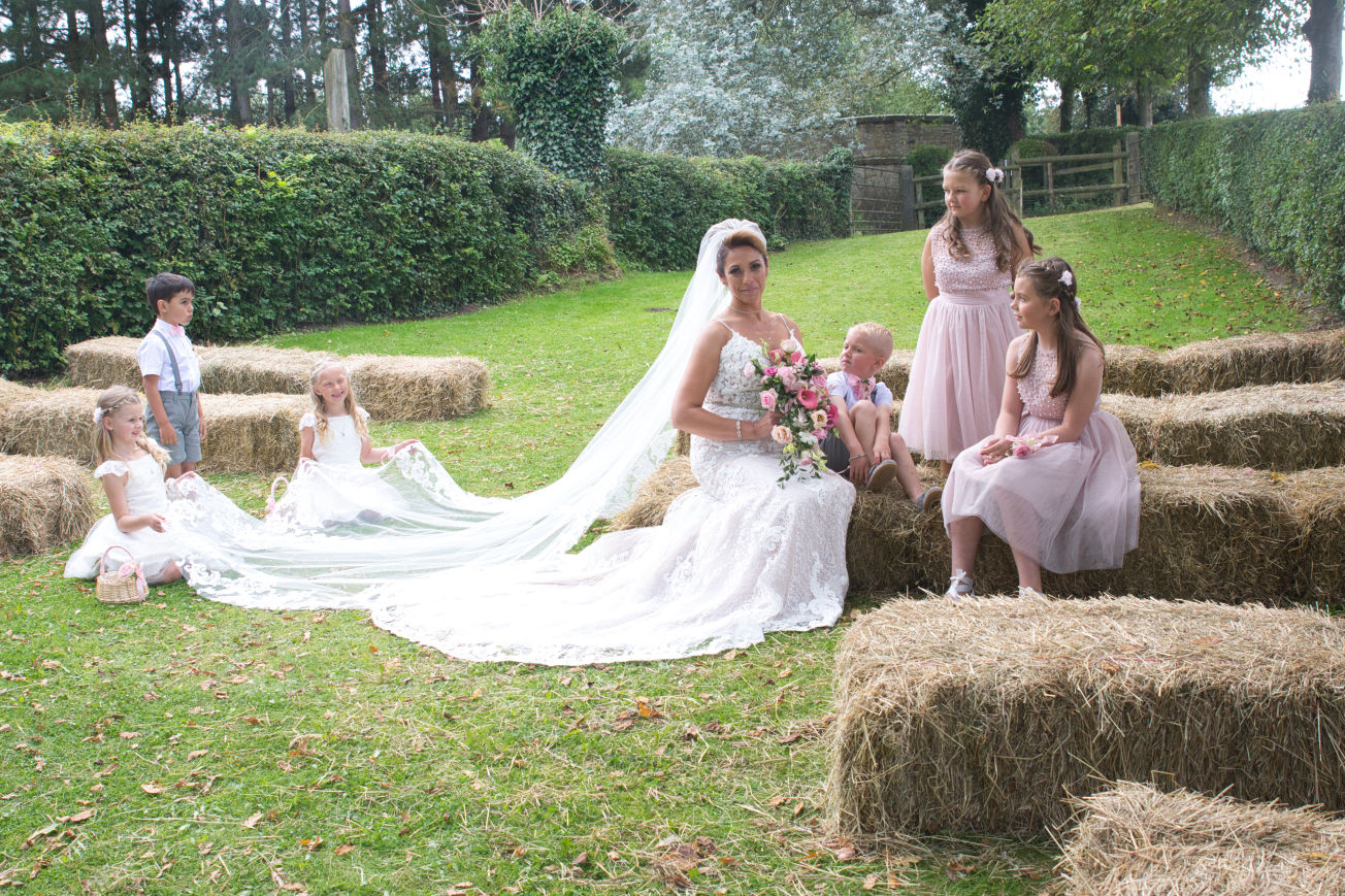 A bride poses were with her nieces and nephews at lyme breeze wedding venue