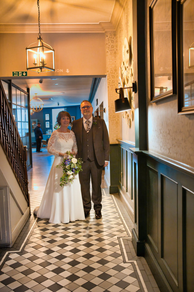 Bride and brother get ready to walk down the isle   at The Stanneylands Hotel wedding reception in Wilmslow